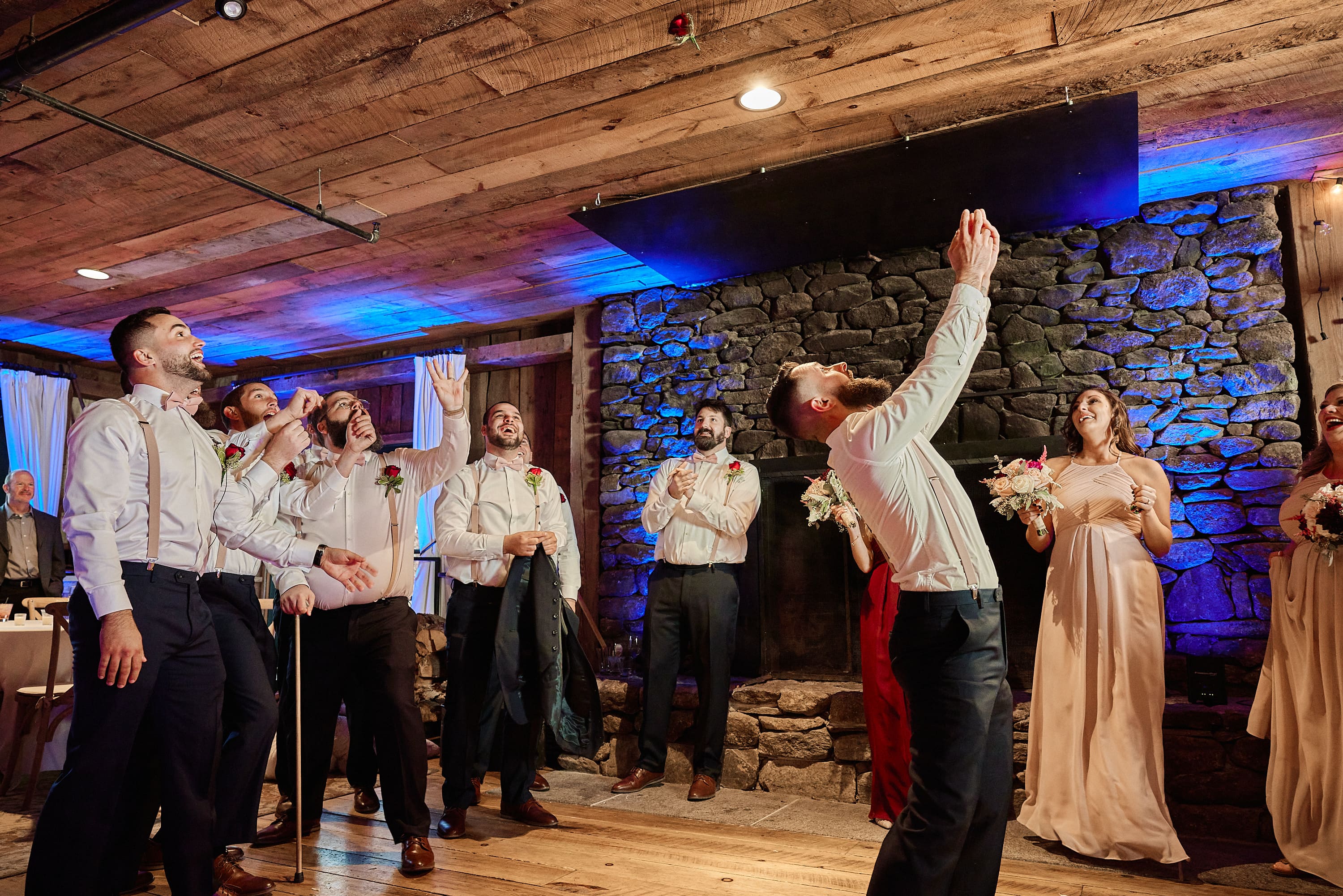 Black and white reception photo of guests celebrating on the dance floor